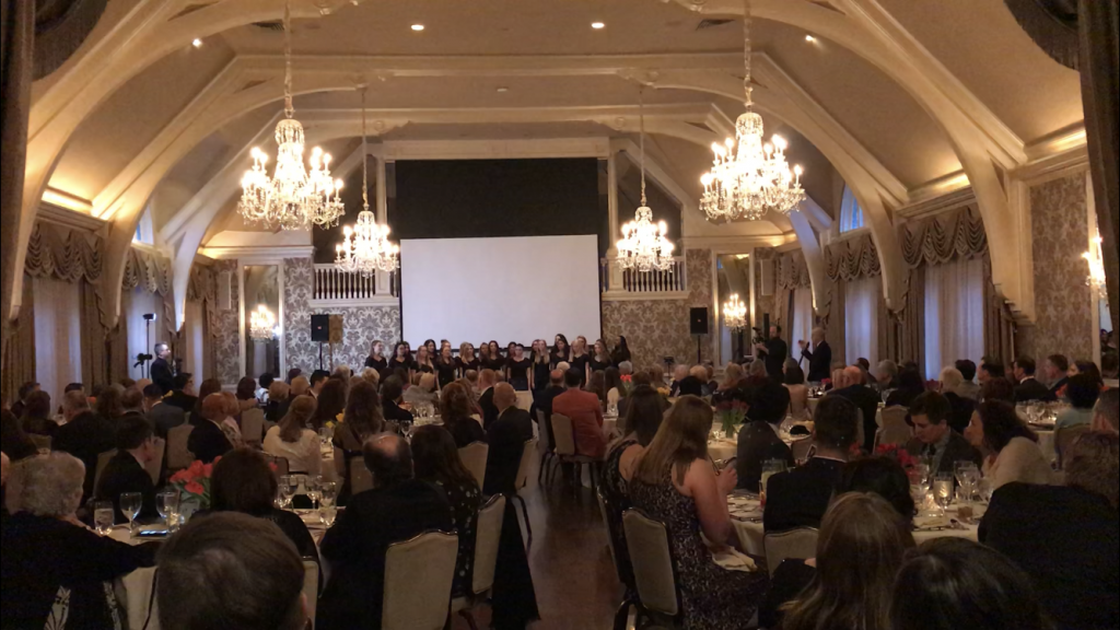 Image of folks sitting at tables in a ballroom at the Clery Center's 30th Anniversary Gala